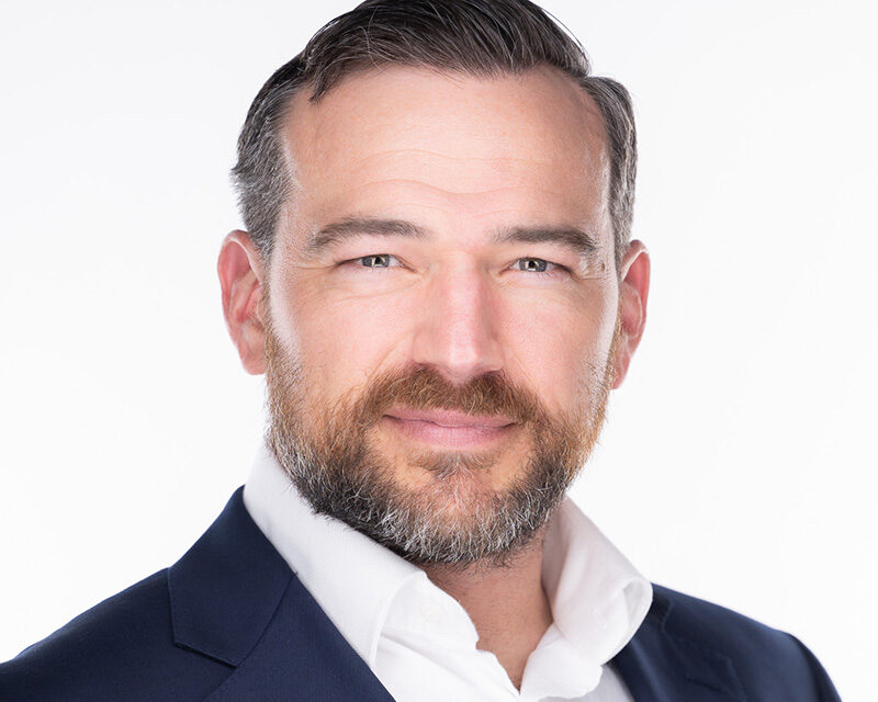 Professional executive headshot photographed in downtown Durham NC.