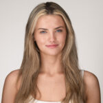 Professional model headshot with natural lighting, showcasing a confident expression and long, wavy hair, relevant for headshot photography tips and modeling agency context in Raleigh-Durham, North Carolina.