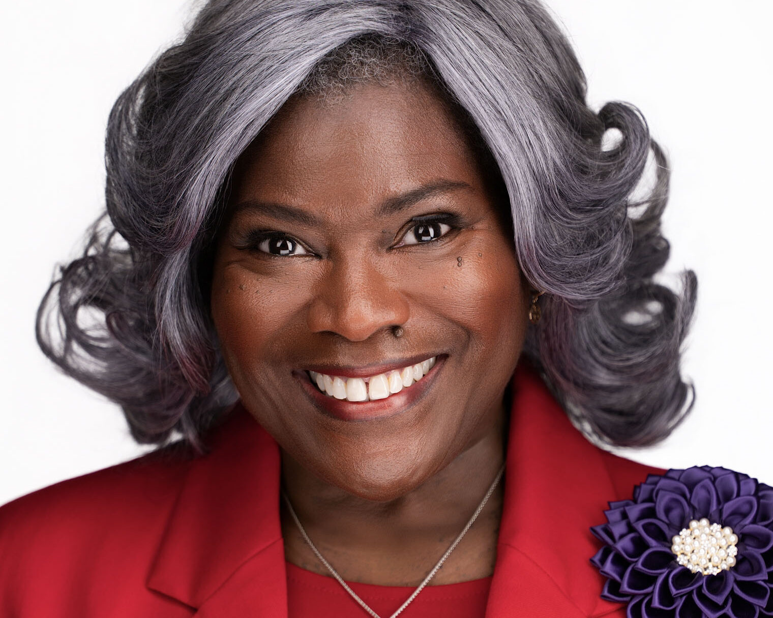Woman in red jacket receiving best headshot for Durham Raleigh